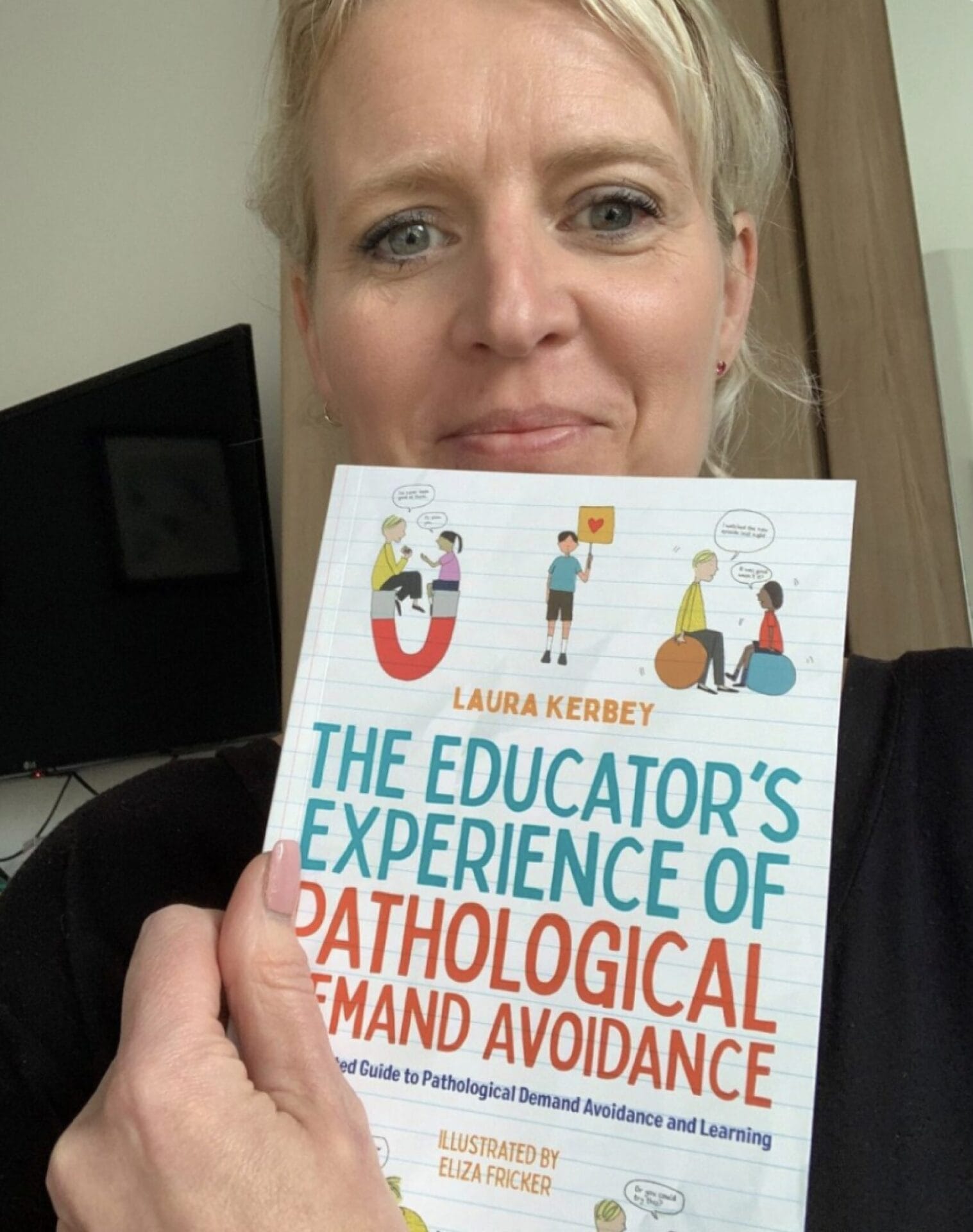 Laura Kerbey holding PDA training book